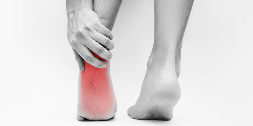 foot-pain-from-uncomfortable-shoes-woman-holds-sore-heel-with-her-hand-isolated-white-background 1.png